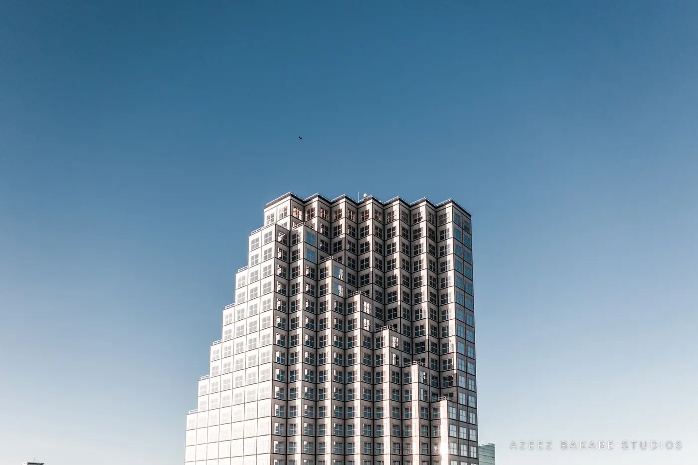 Stepped high-rise tower against a clear sky, Miami, architectural photograph by Azeez Bakare Studios